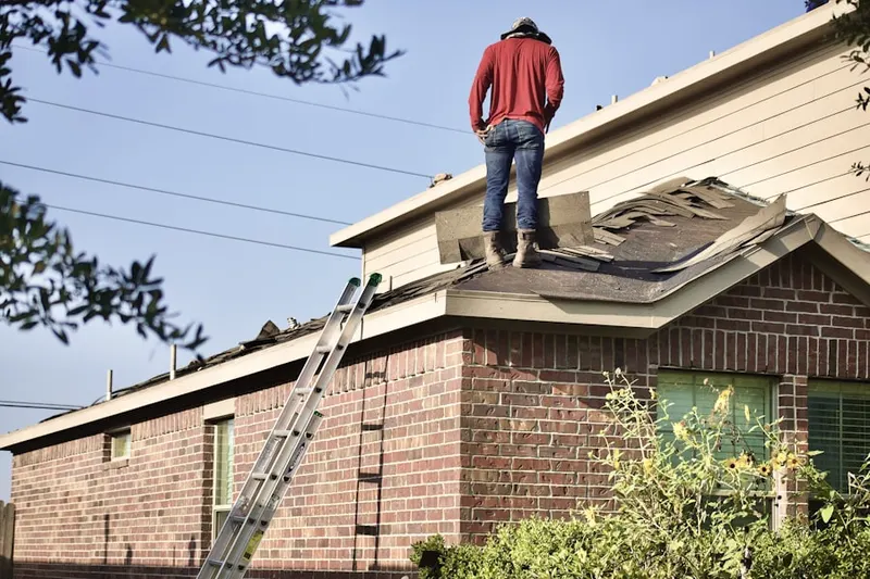 Professional roofer working on a residential roof in Spring Country
